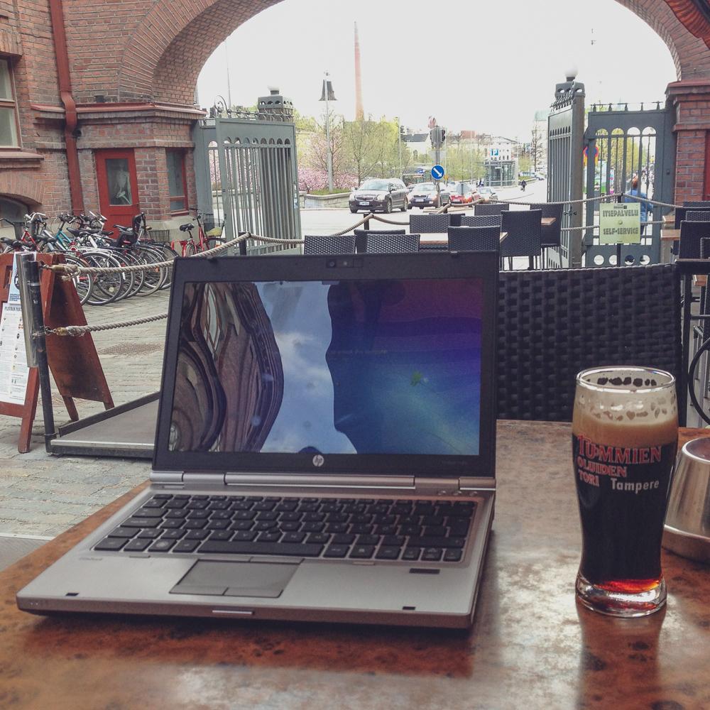 Laptop and beer on table